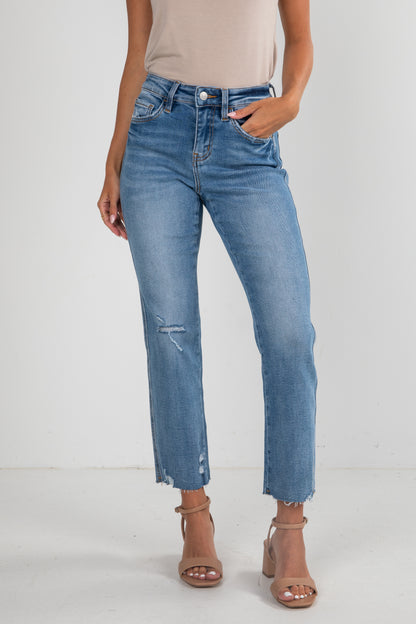 Person wearing blue jeans on a white background