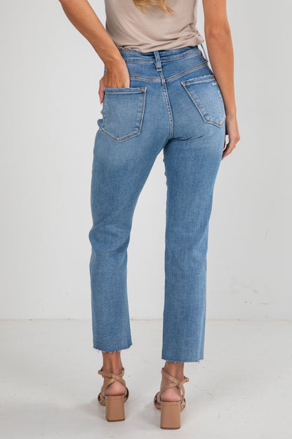 Person wearing blue jeans on a white background