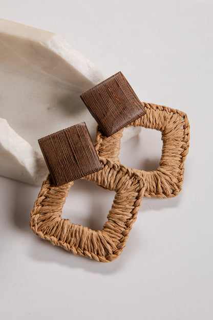 Brown woven earrings on a light background