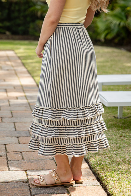 Woman wearing striped maxi skirt. 