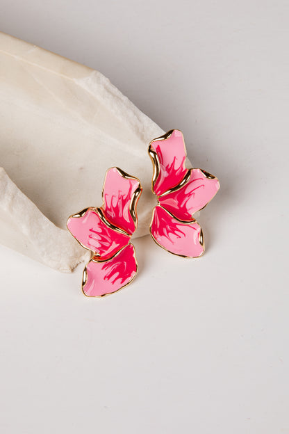 Pink butterfly-shaped earrings on a light background