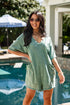 Woman wearing a green dress standing by a pool