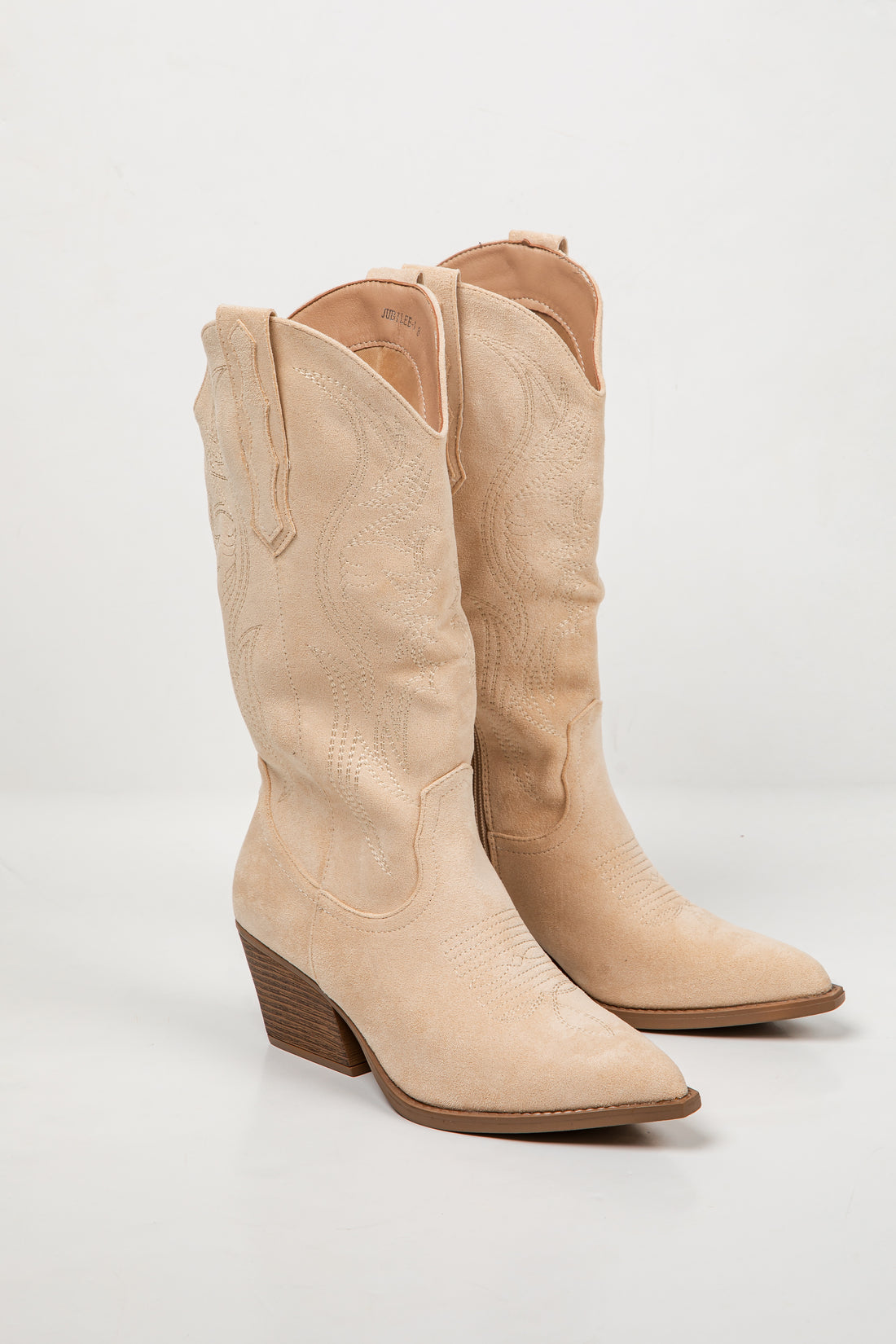 A pair of light beige faux-croc leather cowboy boots with pointed toes and low block heels, shown on a white studio background.