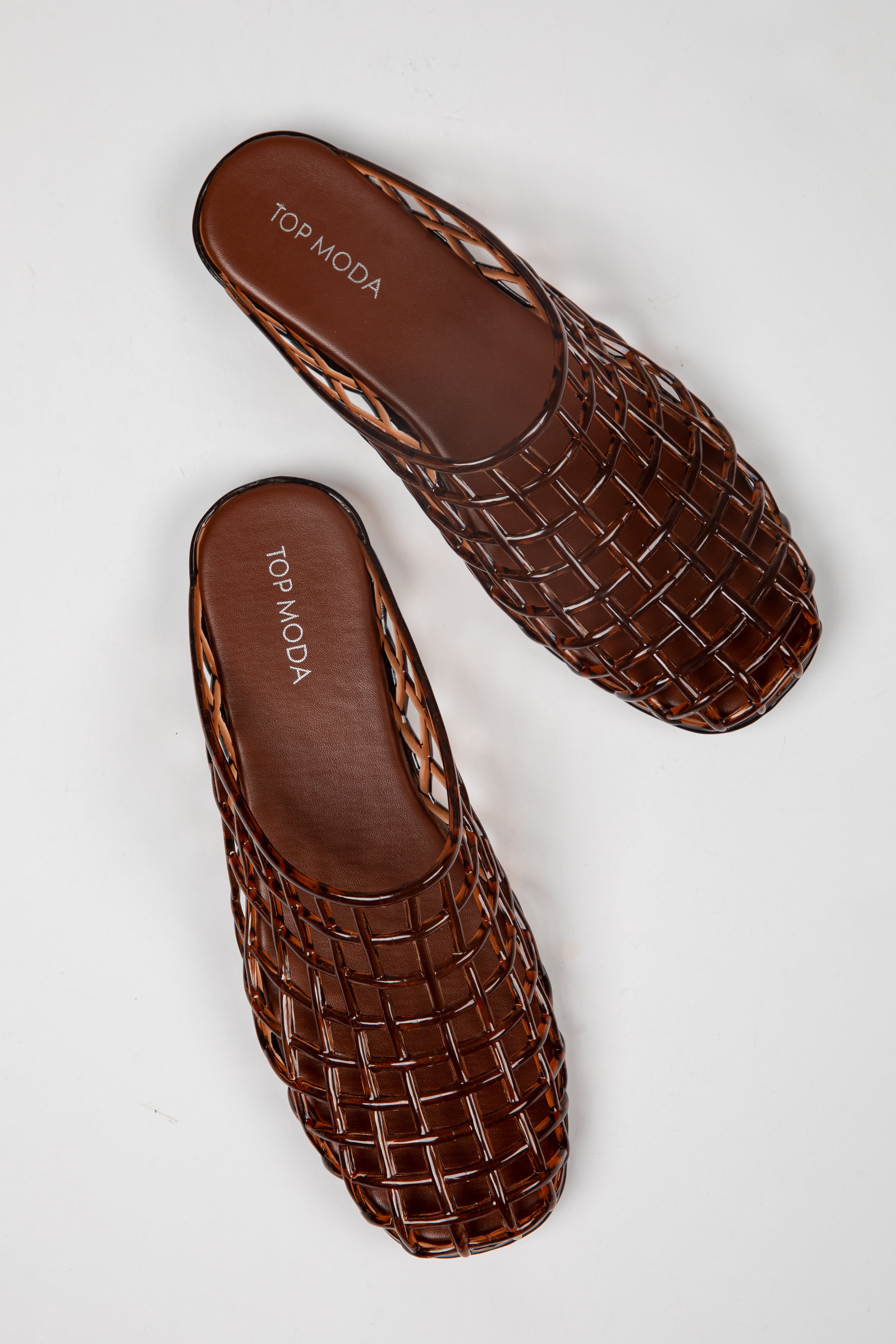 A pair of brown woven leather mule sandals with a square toe, displayed on a clean white background. The brand name &