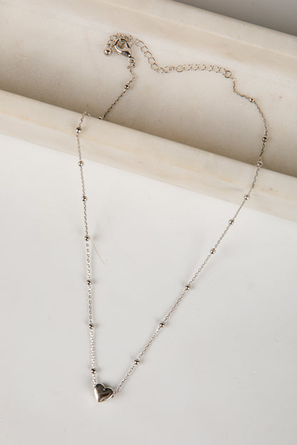 Necklace with a heart pendant on a light background