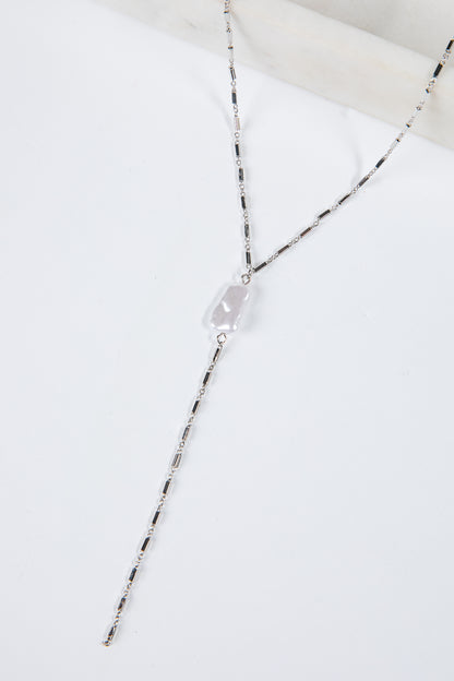 Necklace with a clear pendant on a white background