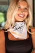 Woman wearing a bandana with &