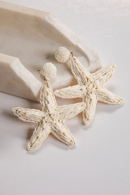 Starfish-shaped earrings on a light background