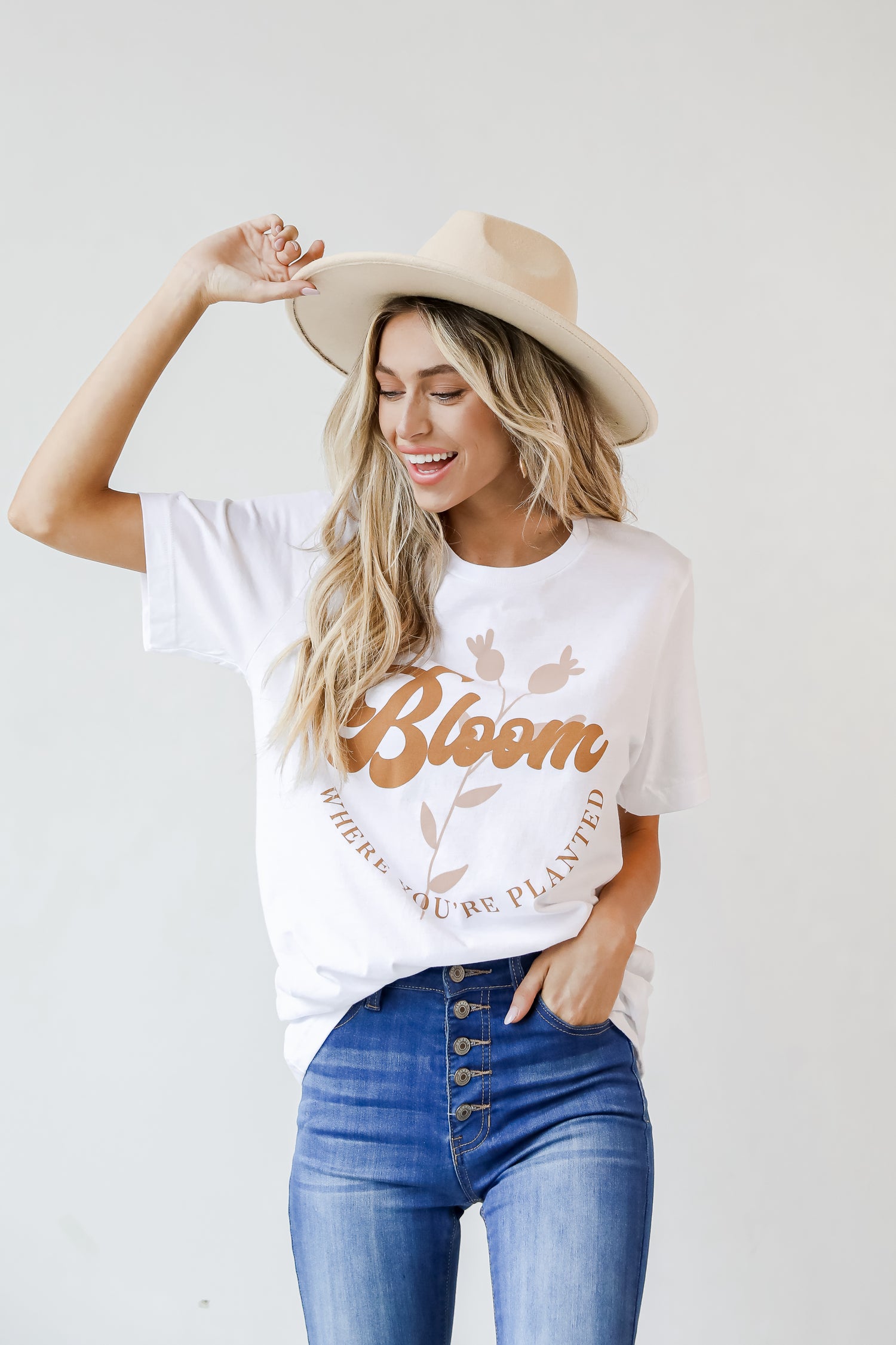 This comfy tee is designed with a soft and stretchy knit. It features a crew neckline, short sleeves, a relaxed fit, and the words "Bloom Where You&