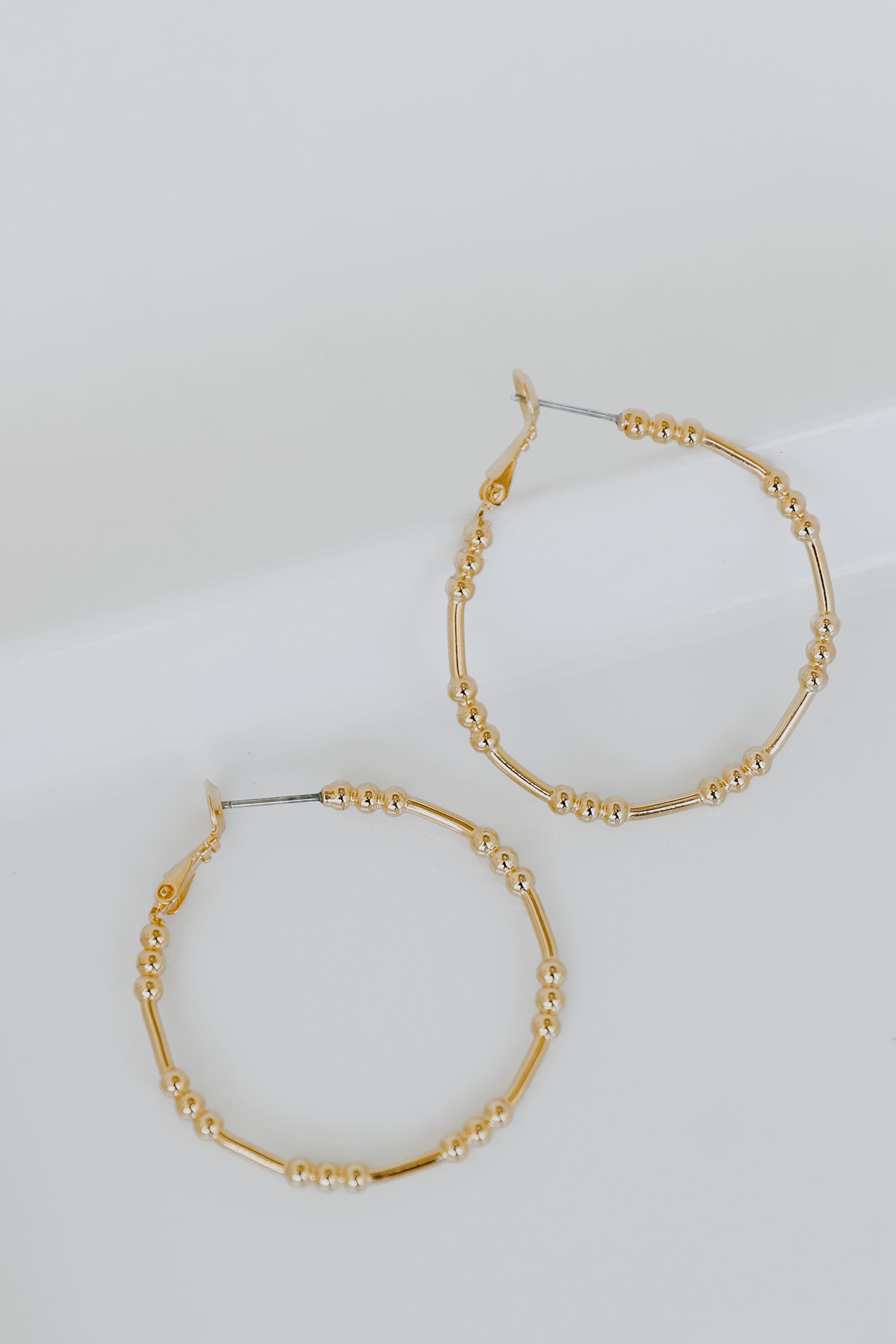 Gold Ball Hoop Earrings flat lay