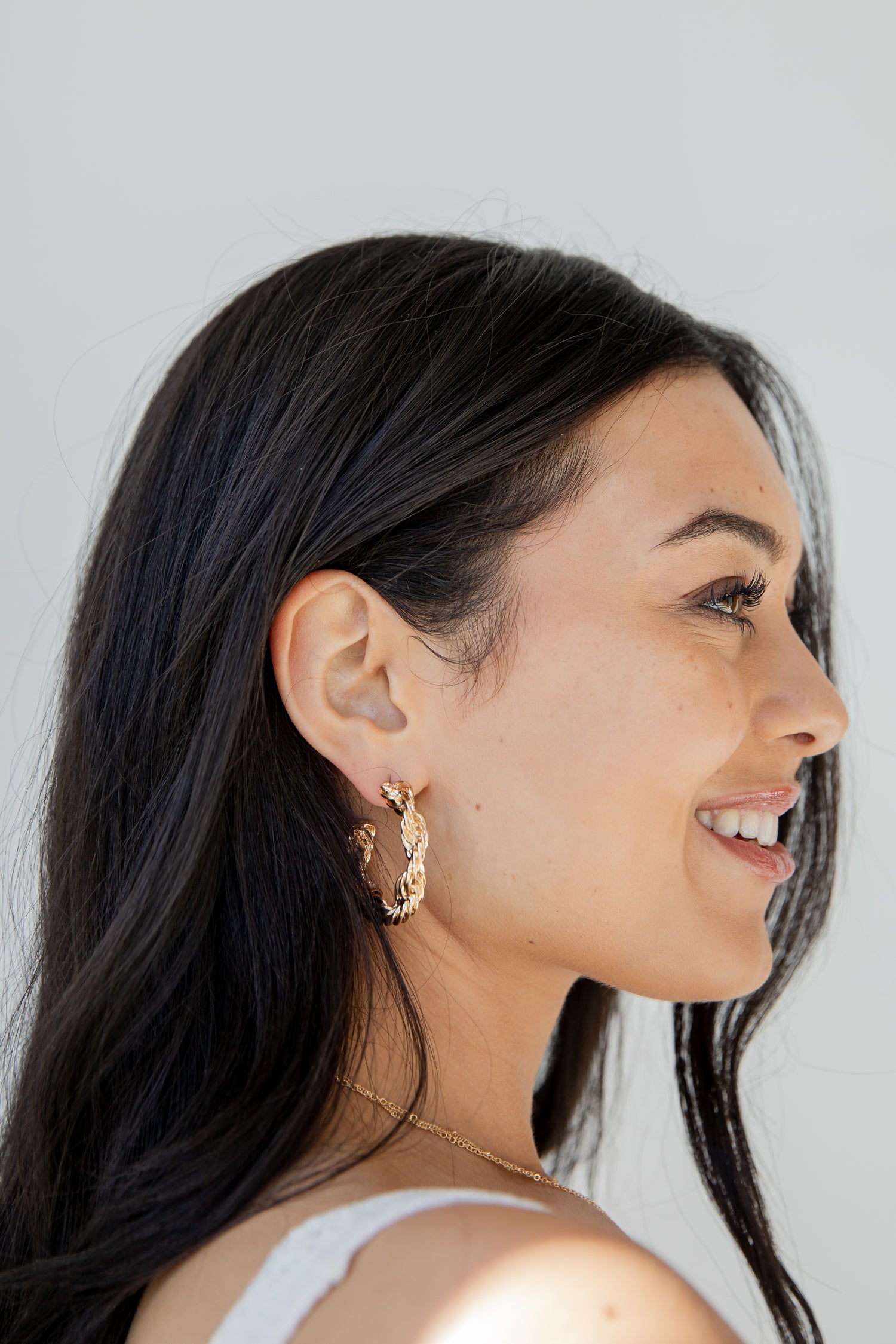 Gold Twisted Hoop Earrings on model