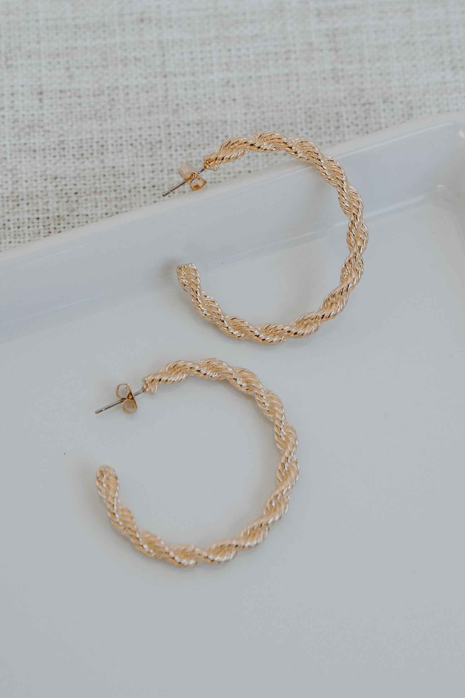 Gold Twisted Hoop Earrings flat lay