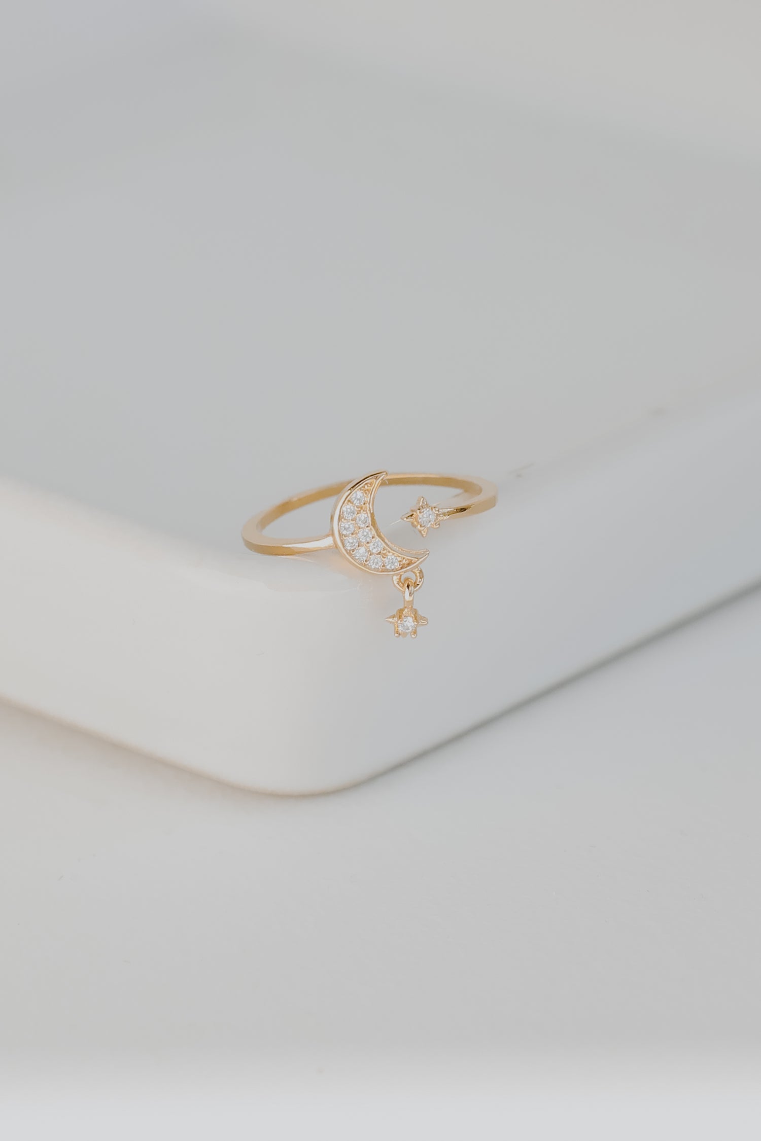 Gold Rhinestone Star + Moon Ring flat lay