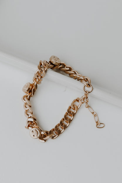Gold Smiley Face Chain Bracelet flat lay