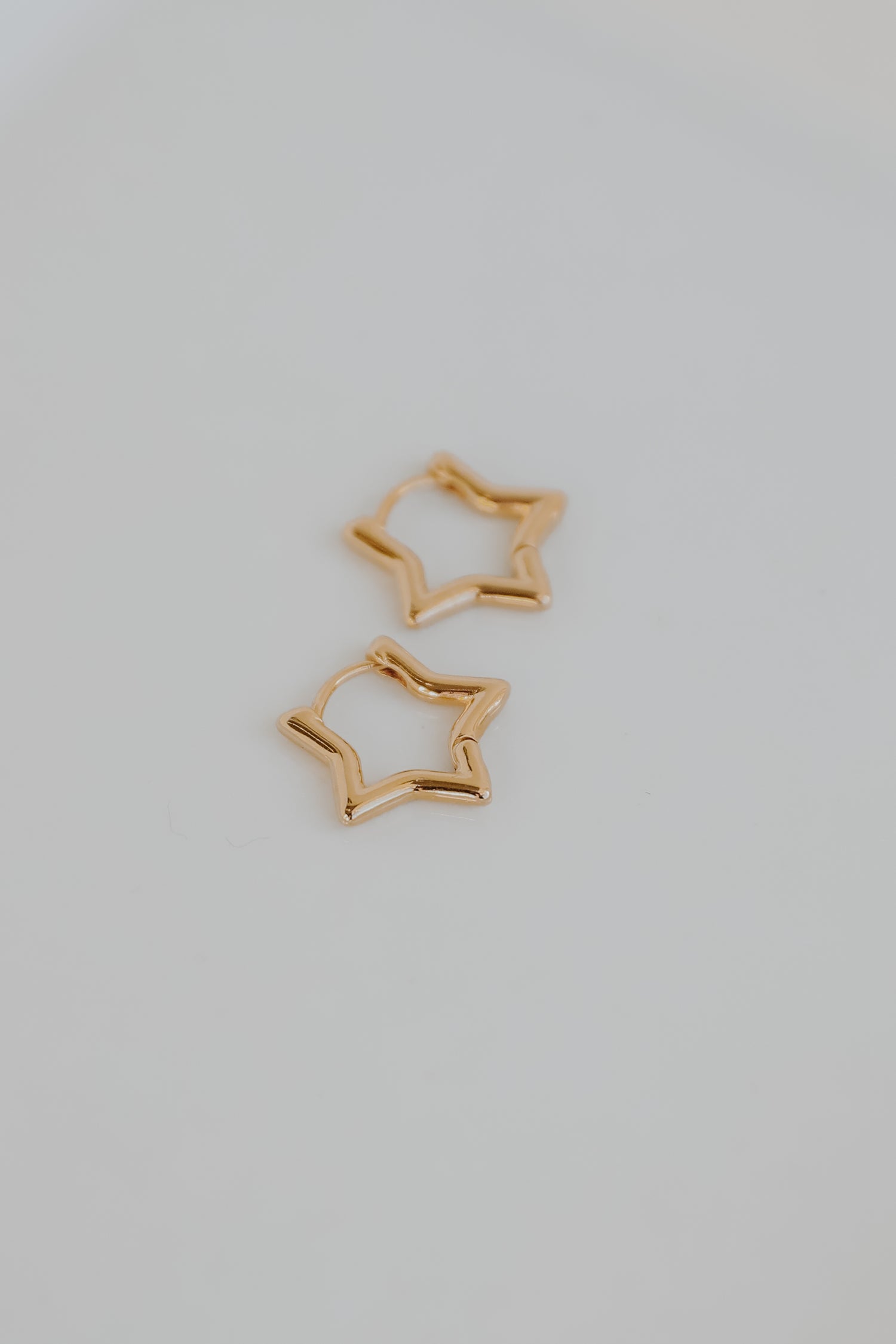 Gold Star Mini Hoop Earrings flat lay