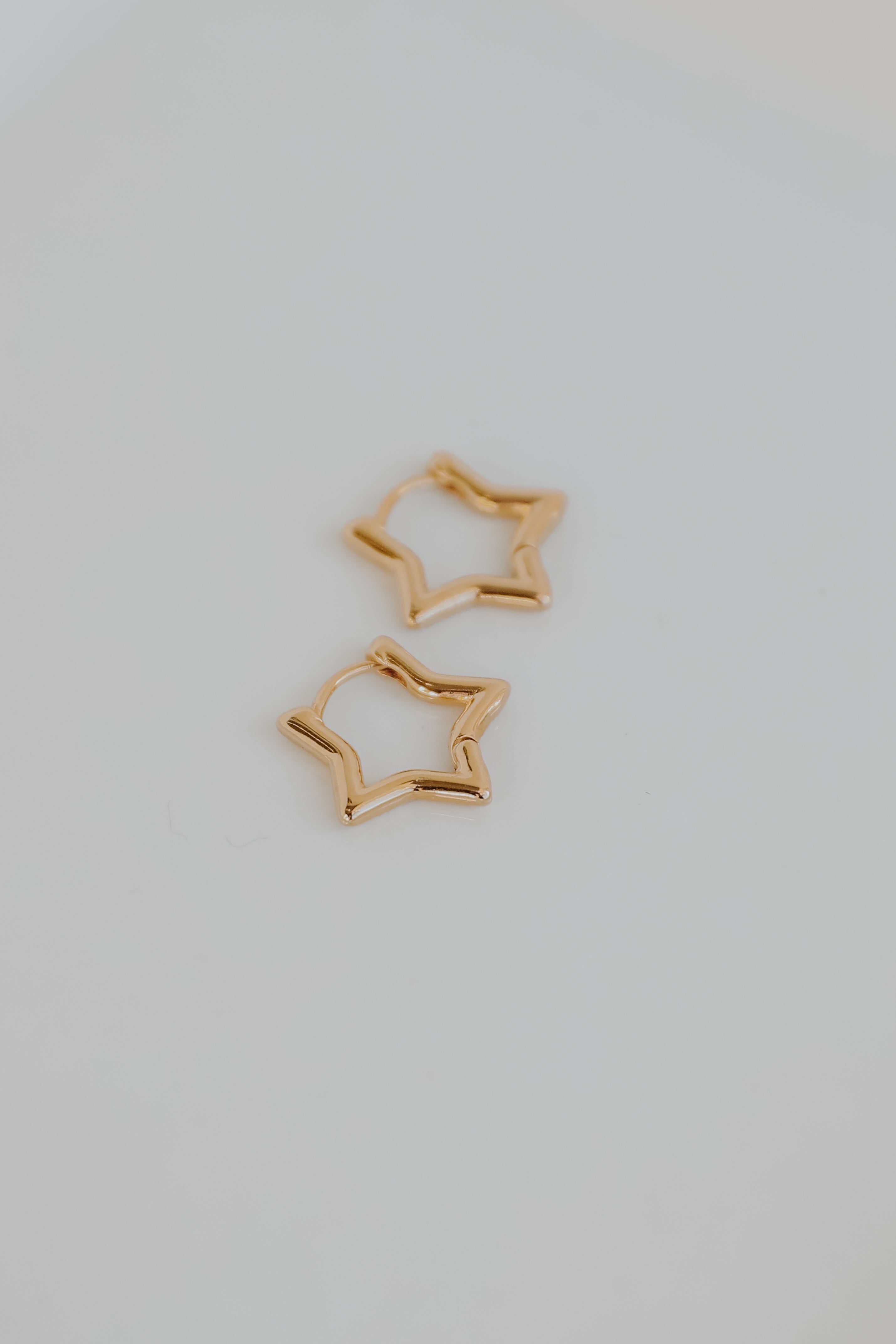 Gold Star Mini Hoop Earrings flat lay