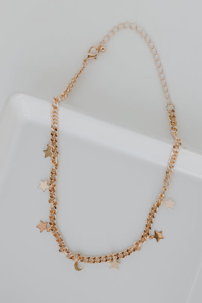 Gold Star + Moon Necklace flat lay