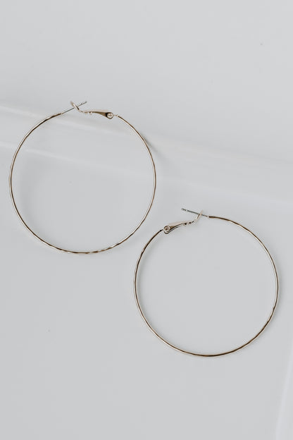 Hammered Hoop Earrings in gold flat lay
