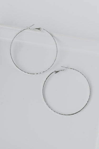 Hammered Hoop Earrings in silver flat lay