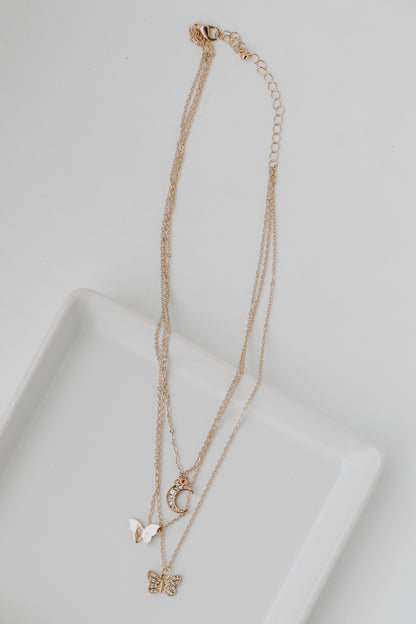 Gold Butterfly + Moon Layered Necklace flat lay