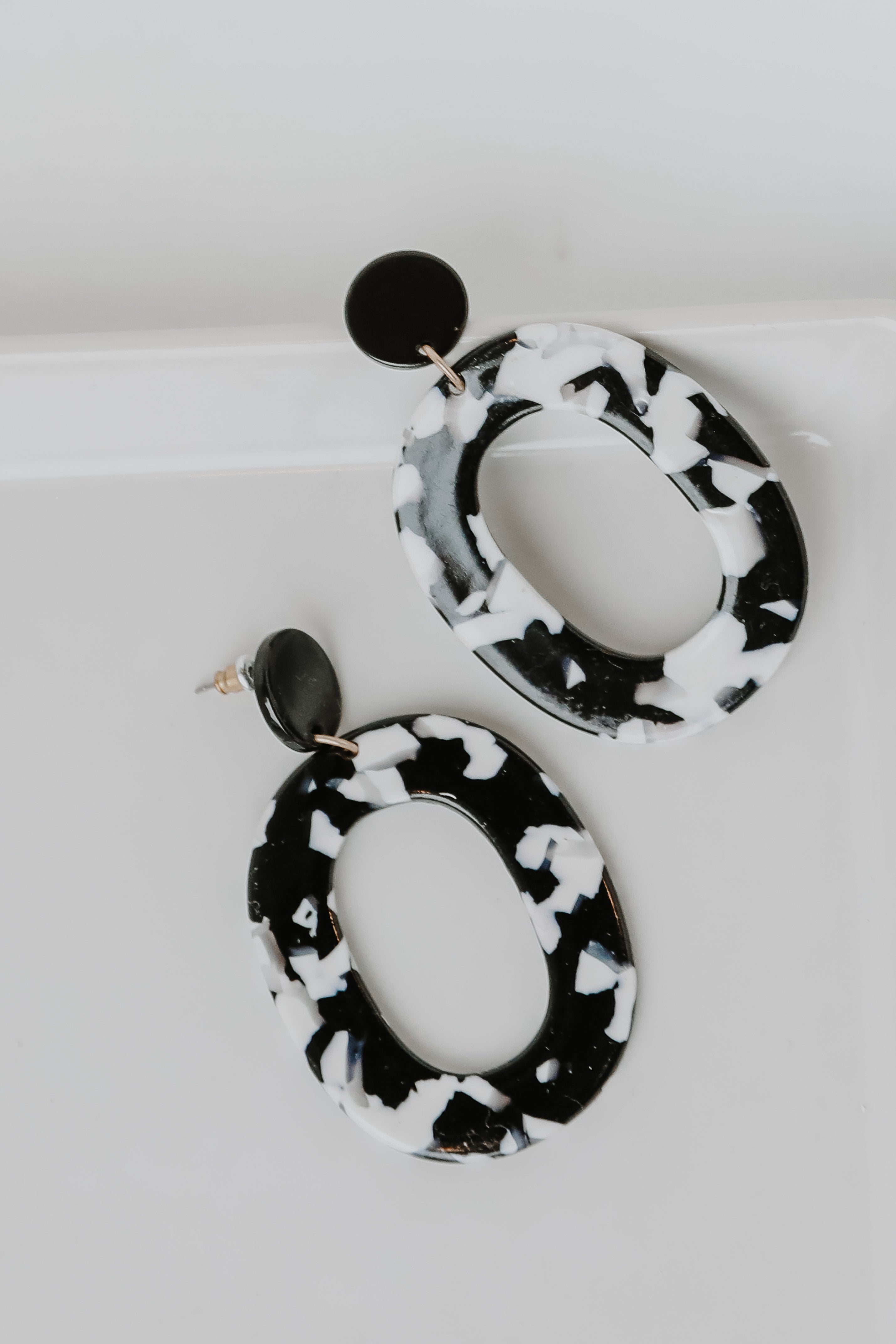 Acrylic Statement Earrings in black flat lay