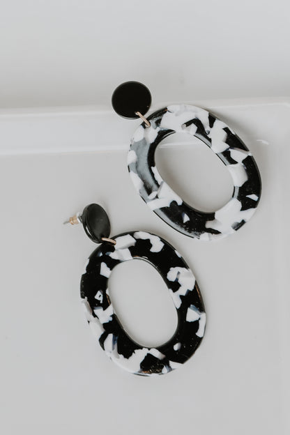 Acrylic Statement Earrings in black flat lay