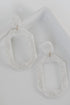 Acrylic Statement Earrings in white flat lay