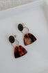 Drop Earrings in black flat lay